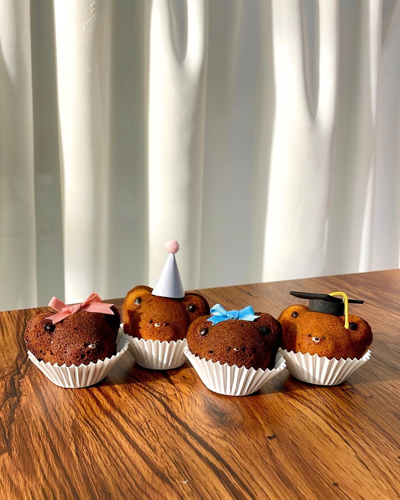 Celebrar teddy madeleines, freshly finished with ribbons and hats